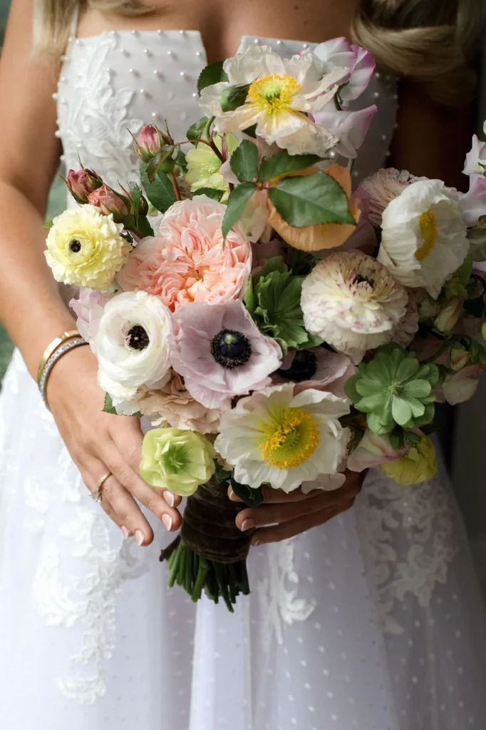 Sally holding her colourful bouquet of flowers on her wedding day