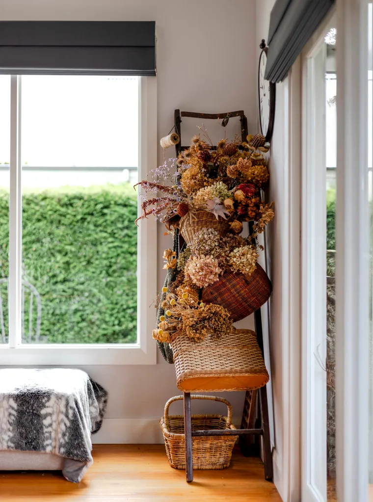 A bedroom with a stack of flower-filled baskets