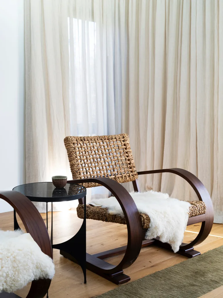 A sculptural timber and rattan armchair