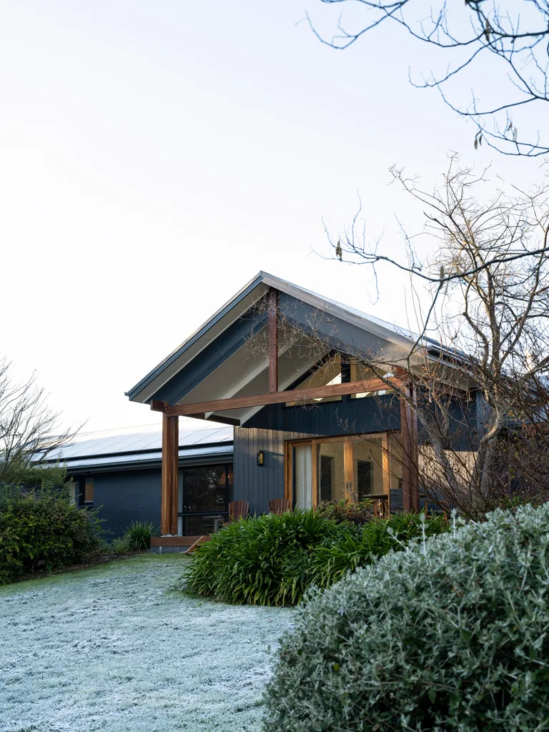 A modern farmhouse-style home surrounded by frosted grass