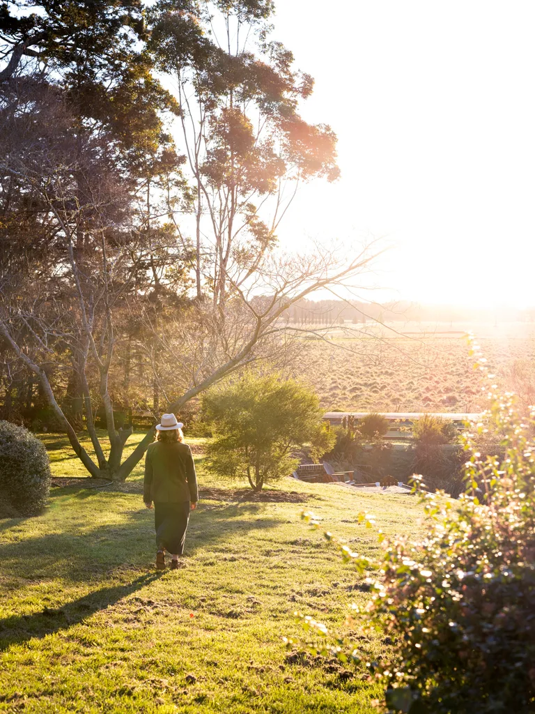 Interior designer Kate walking on her green property in the Southern Highlands