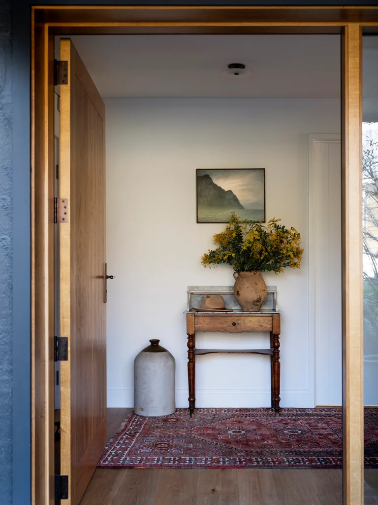 A large timber door opening to an entry hall