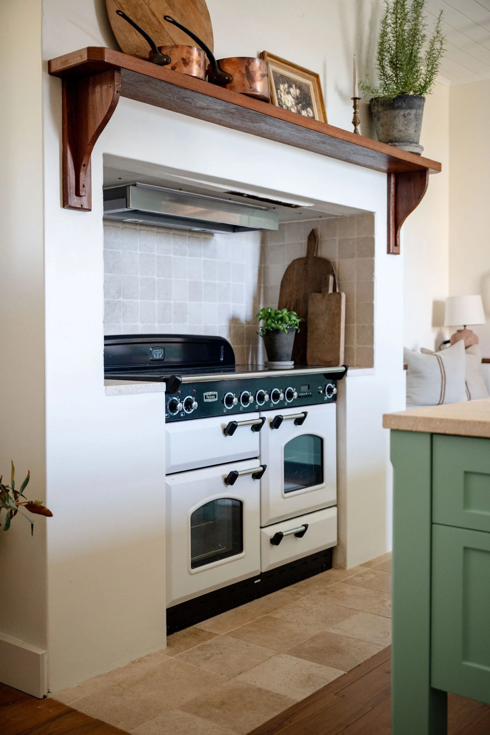 A cosy country kitchen with a tiled alcove for the stove and oven
