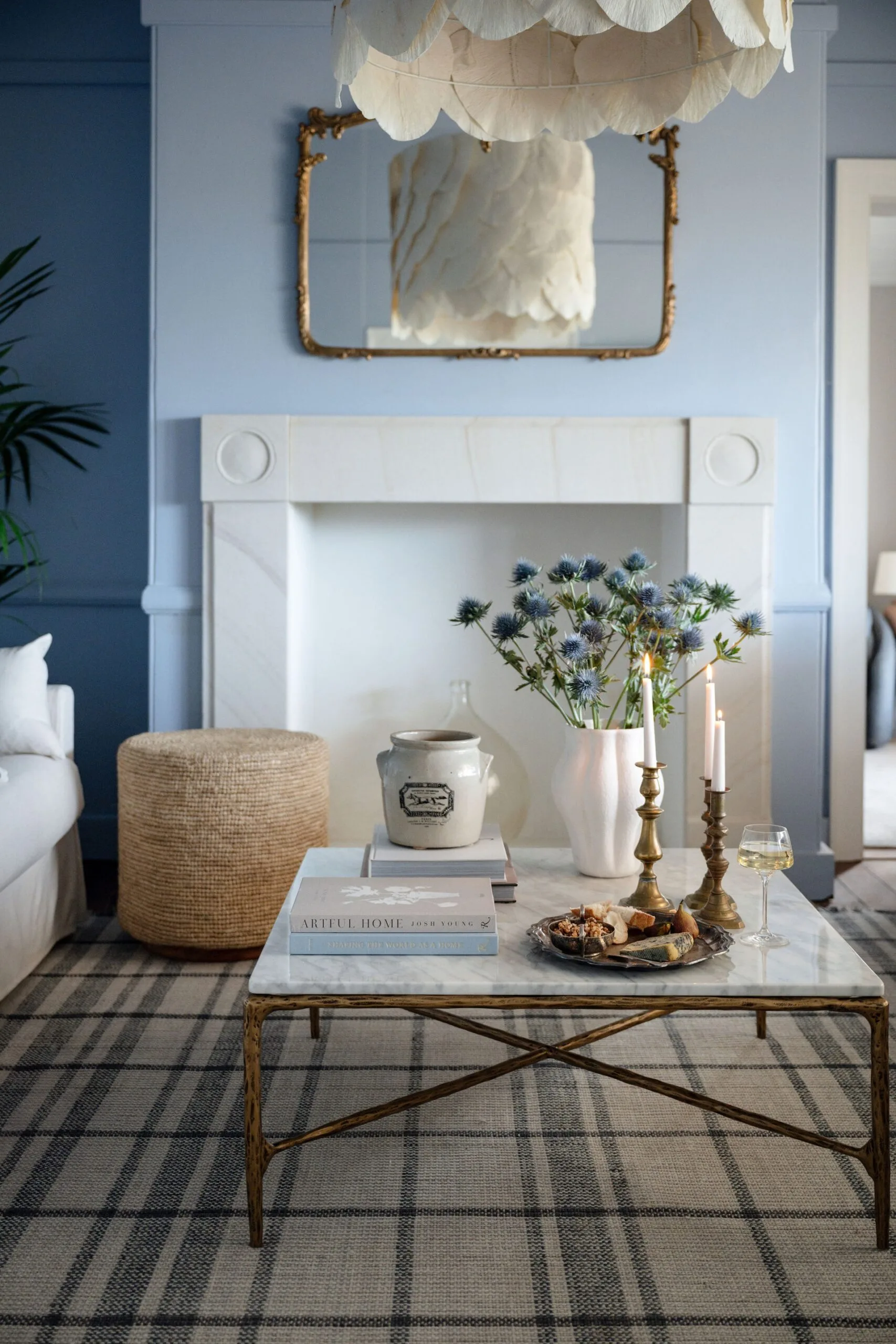 A powder blue sitting room with a marble coffee table