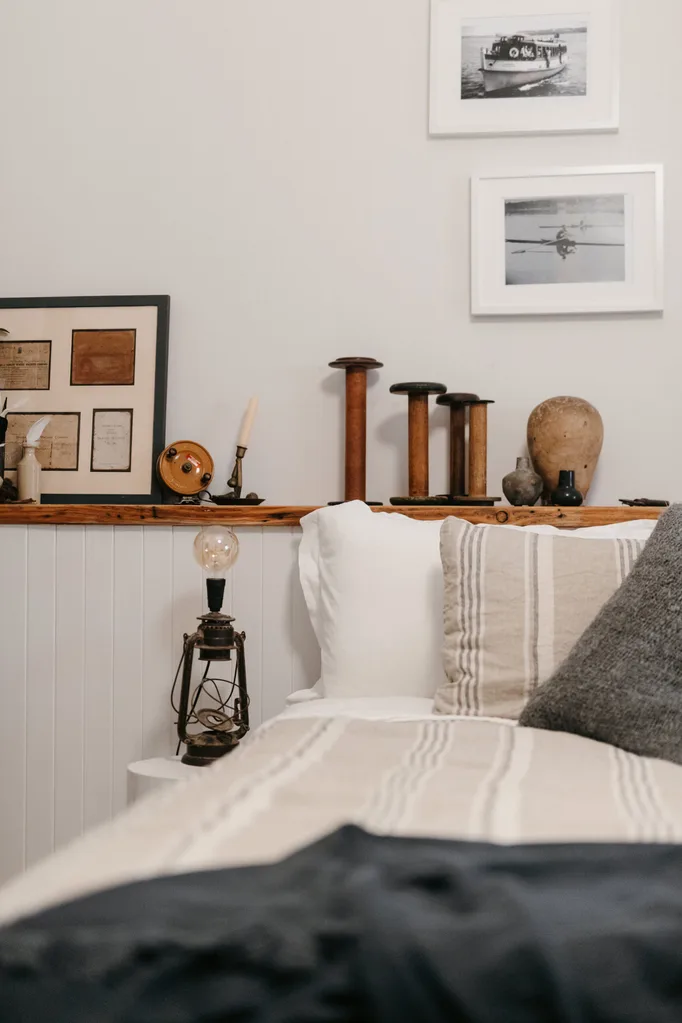 A bedroom with nautical linen and vintage decor