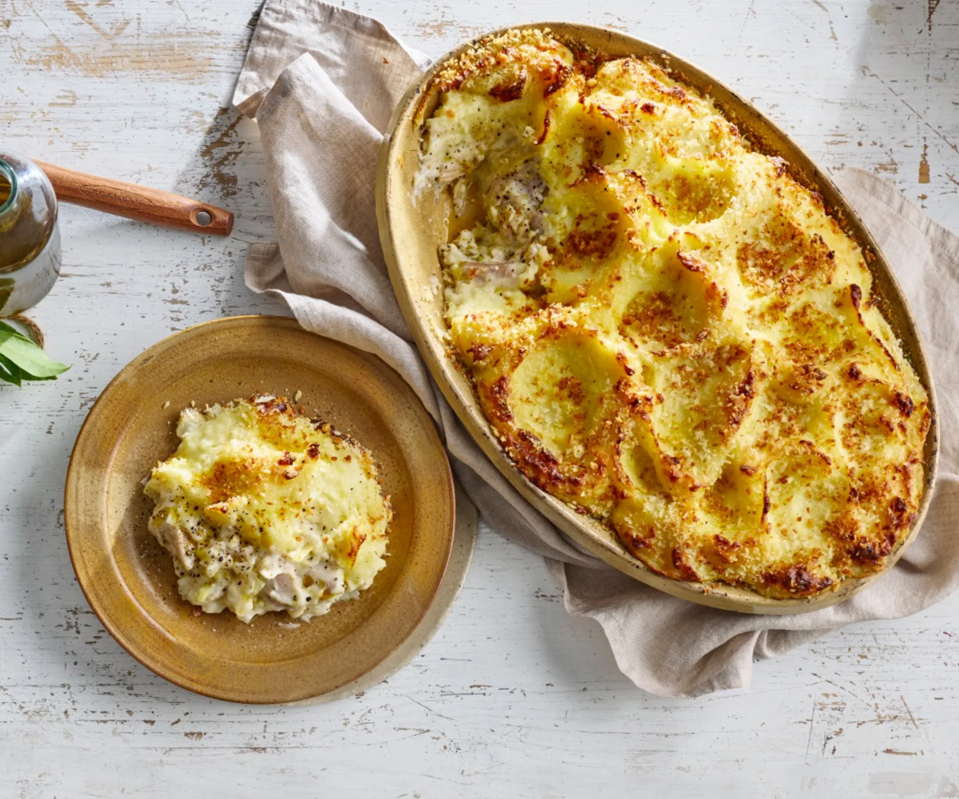 A cheese, potato and leek pie on a timber table
