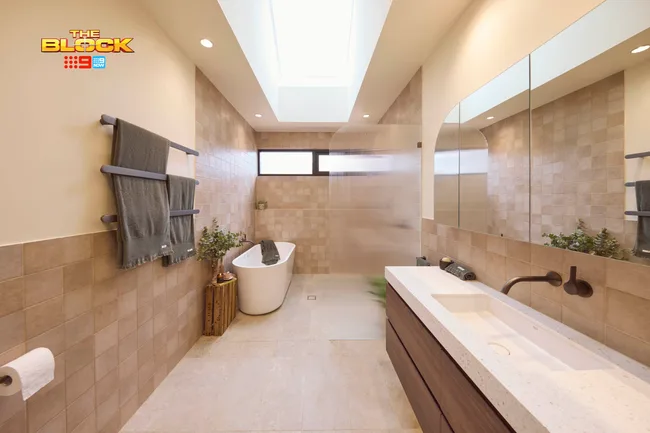 A neutral tone bathroom with a bathtub and walk-in shower
