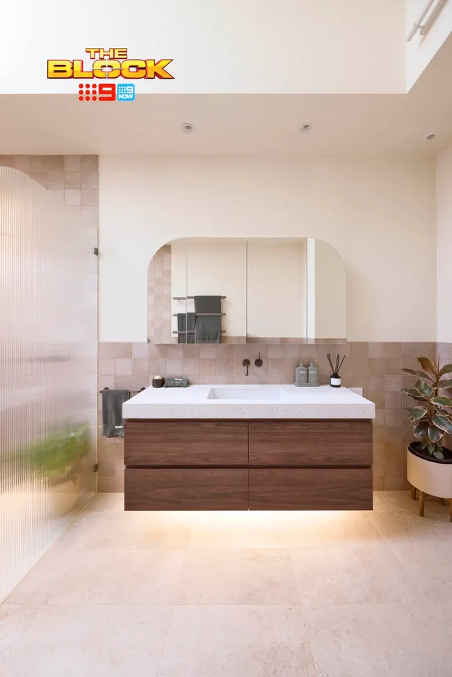 A neutral toned bathroom with a floating timber vanity