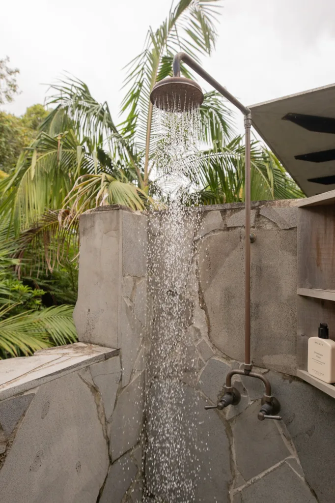 An outdoor shower overlooking the treetops
