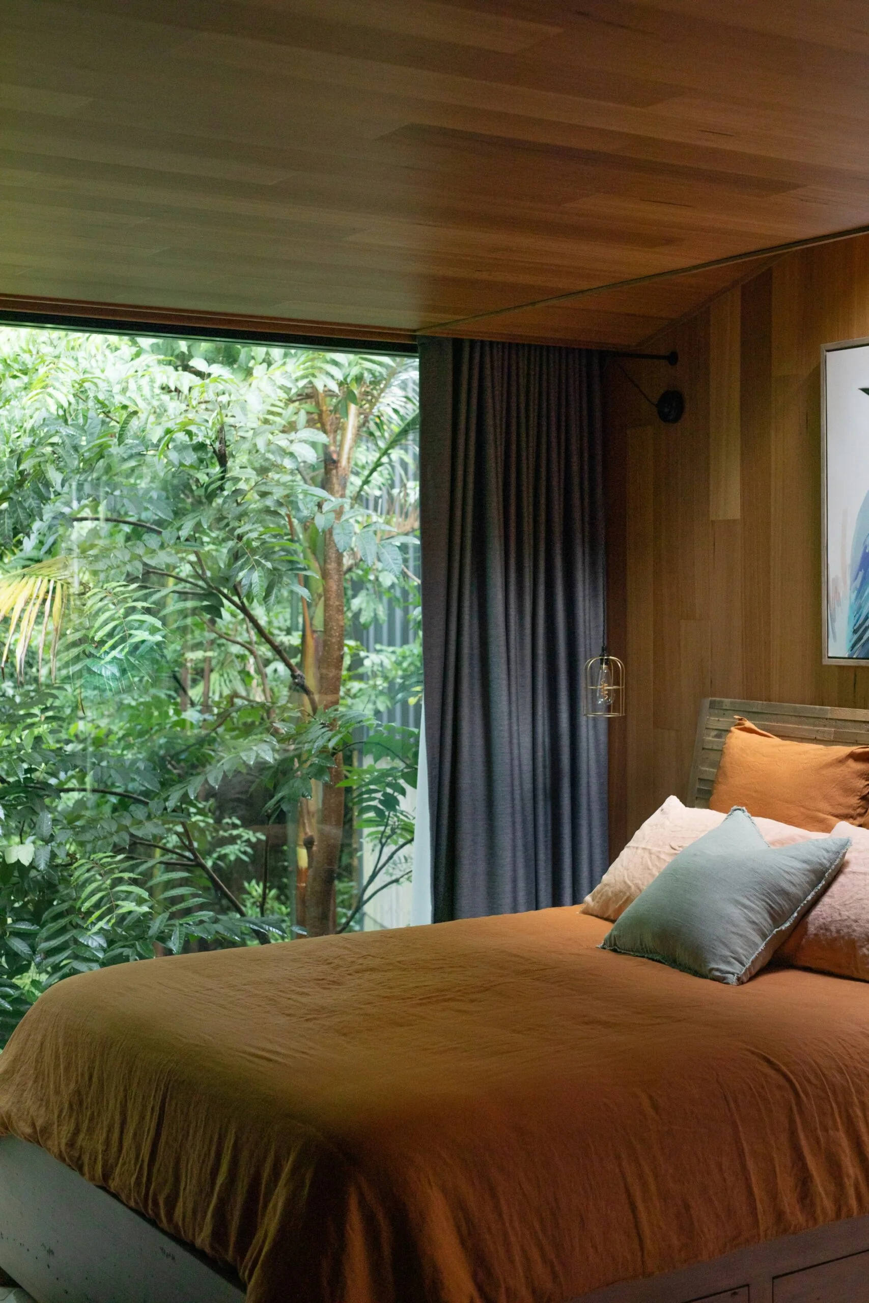 A modern bedroom with timber panelling at Amaroo Bangalow