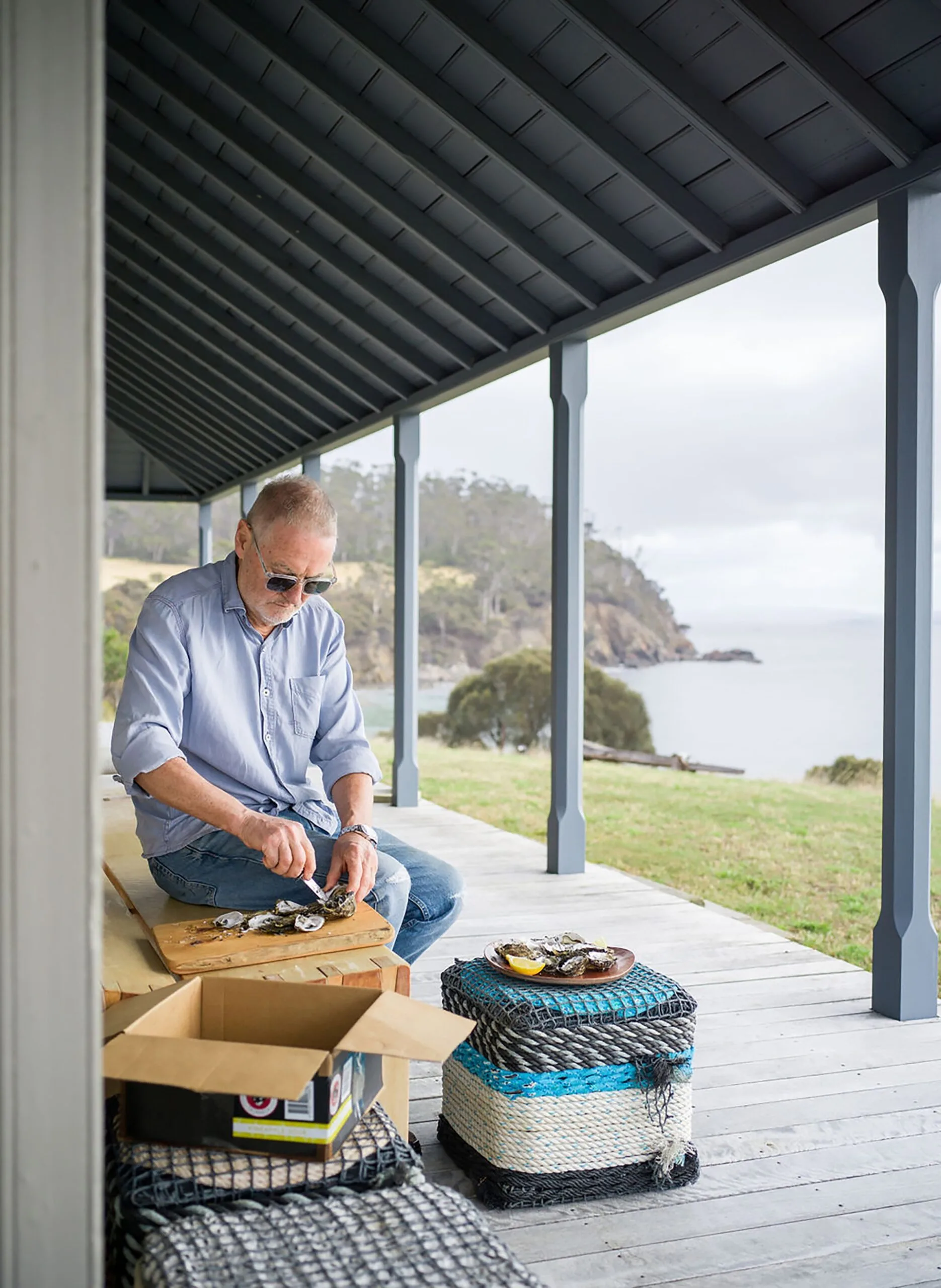 Owner and architect John Wardle shucking oysters outside Captain Kelly's Cottage