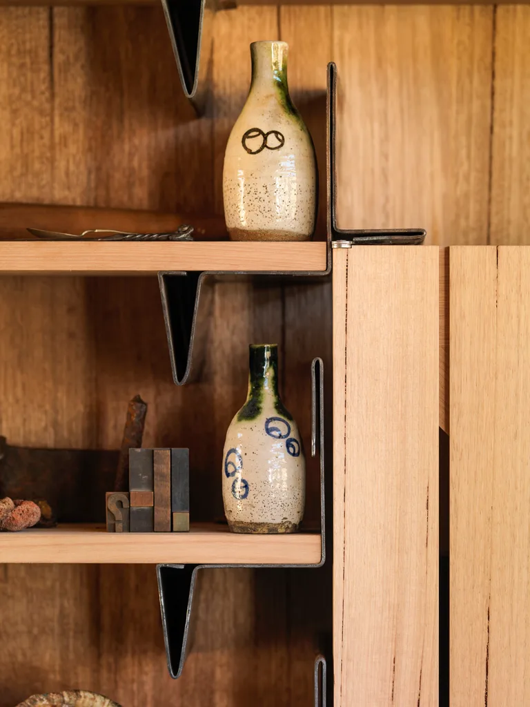Small ceramic vases on a timber shelf