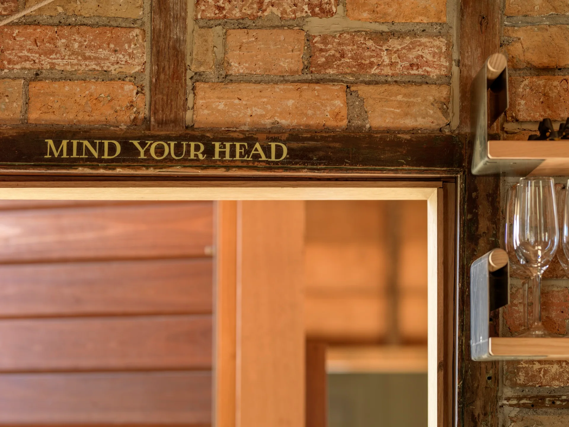 A 'Mind Your Head' message on a door frame