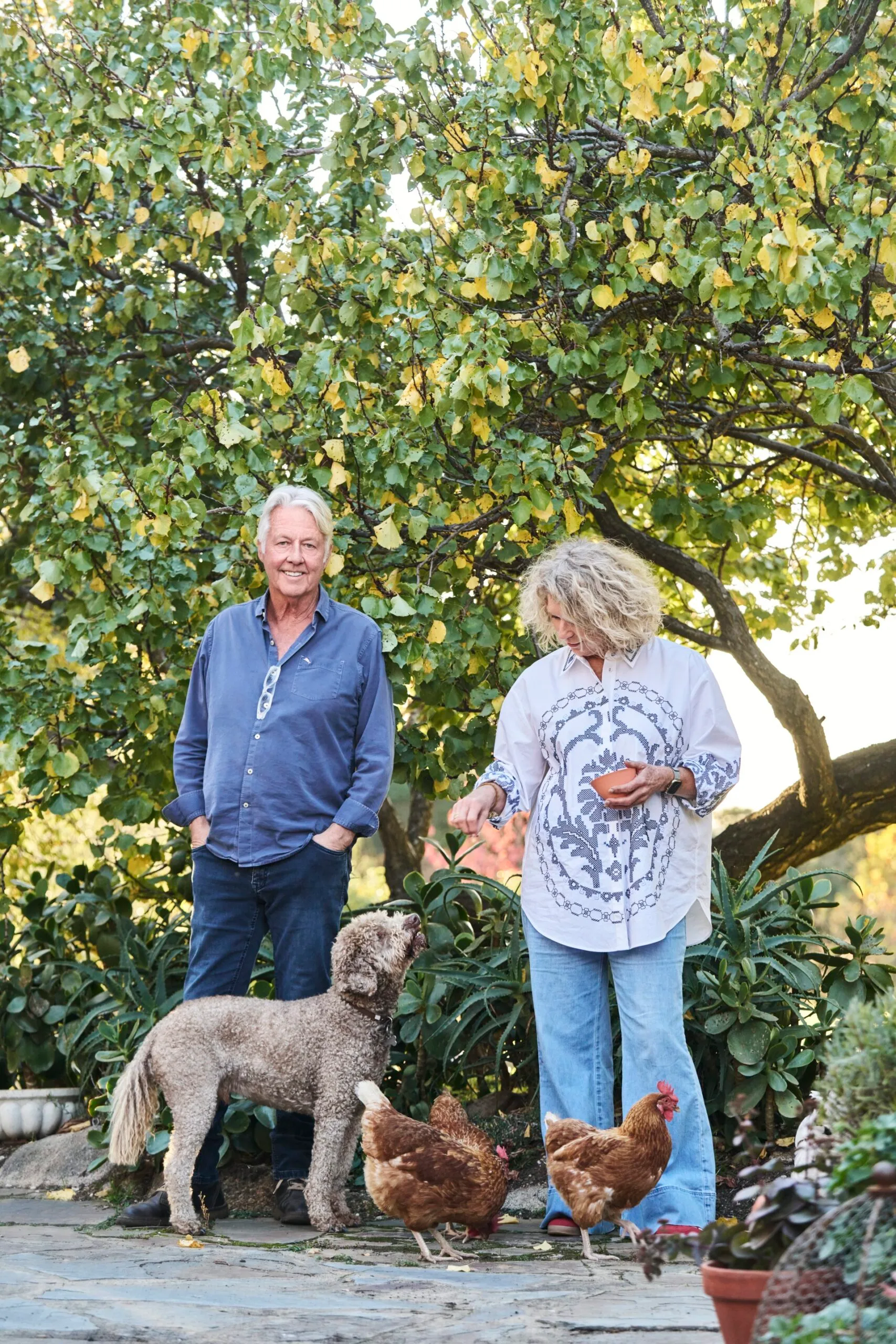 Owners Neil and Lisa with their dog and chickens in their garden