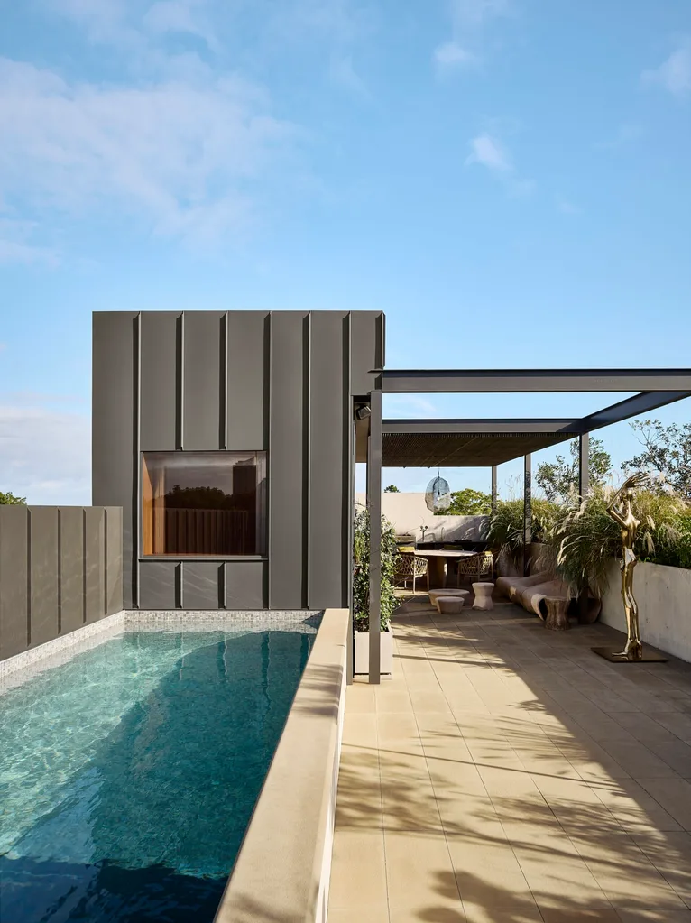 A concrete lap pool on a rooftop terrace