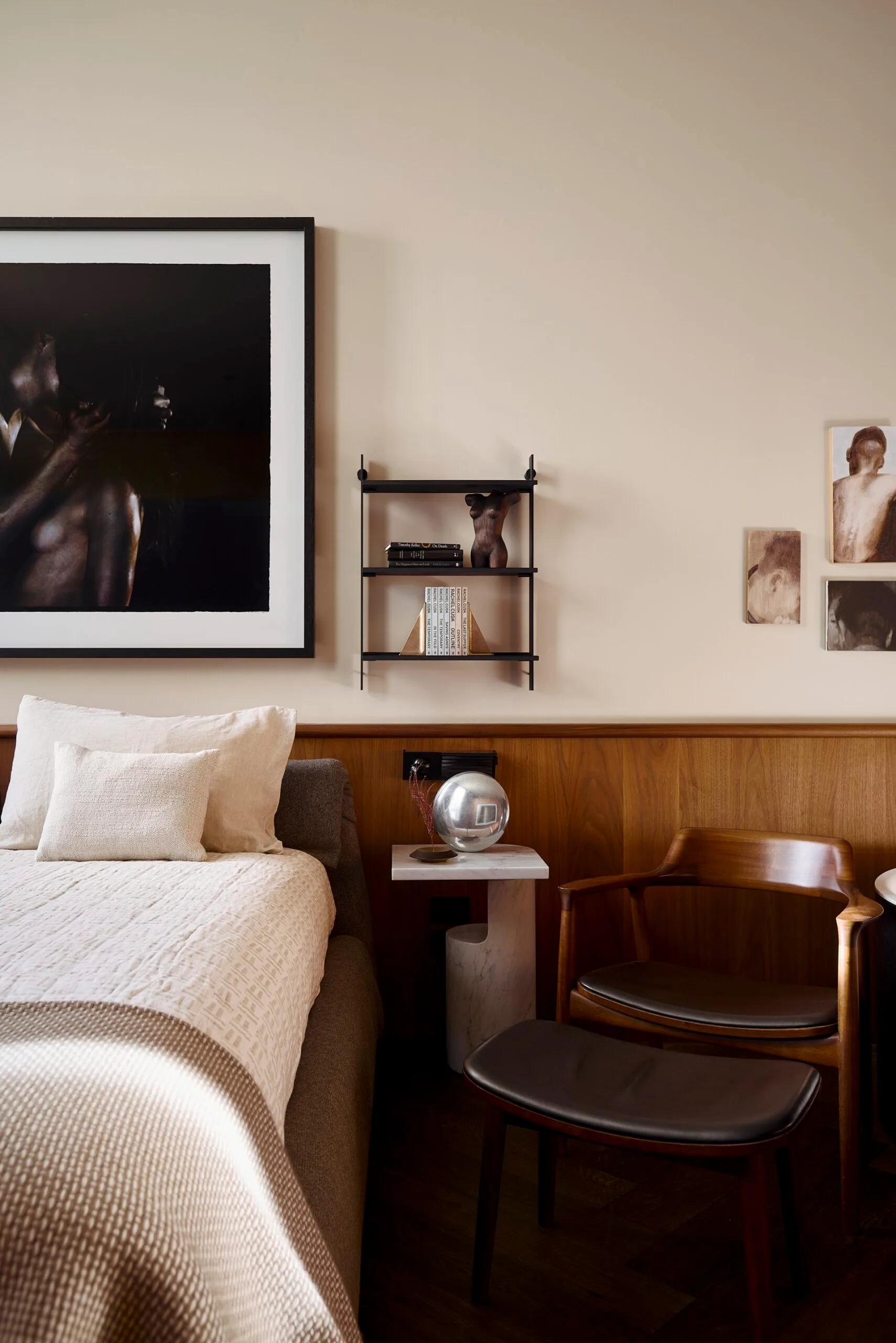 A modern, neutral-toned bedroom with timber panelling