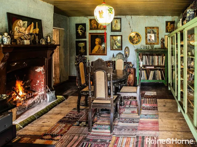 A dining area with a roaring fireplace in Rainham estate