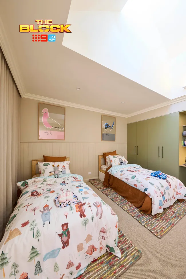 Robby and Mat's kids bedroom with twin beds and framed bird illustrations on the wall