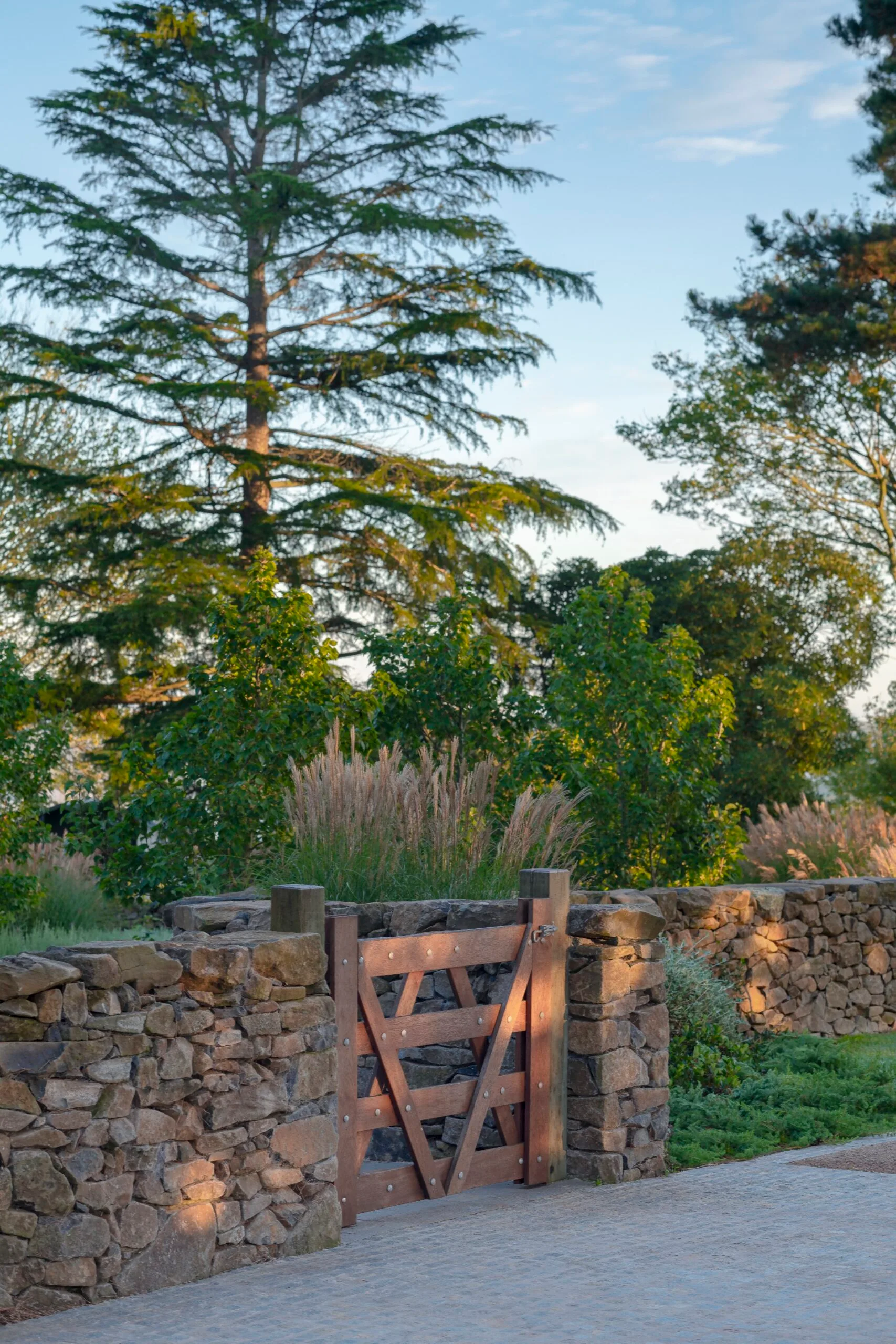 A stone wall beside a garden