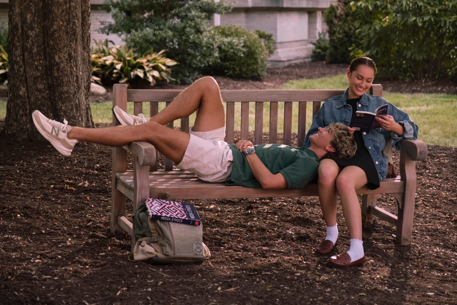 Jeremiah (Gavin Casalegno) and Belly (Lola Tung) sat on a bench in The Summer I Turned Pretty