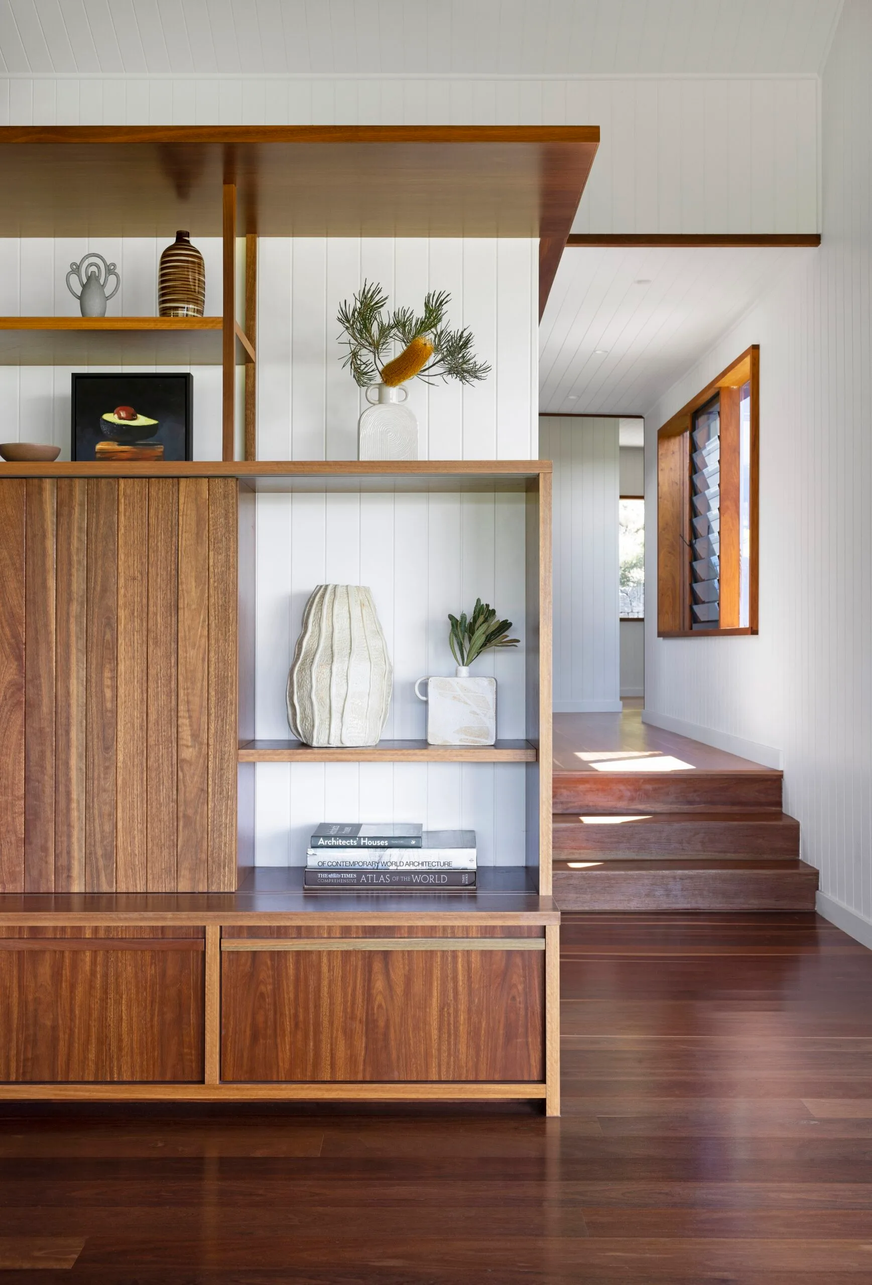 Shelving decorated with ceramics and an avocado painting