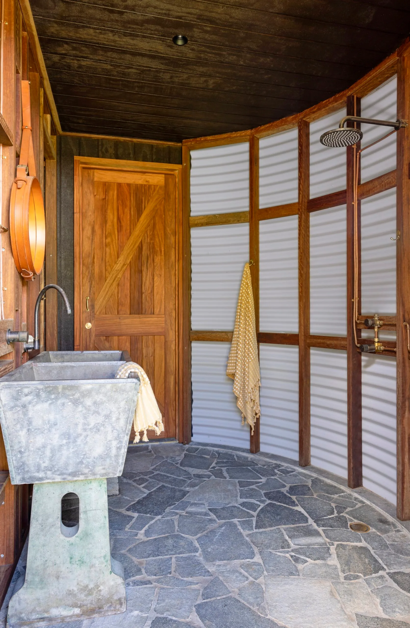 A repurposed rainwater tank acts as a mudroom