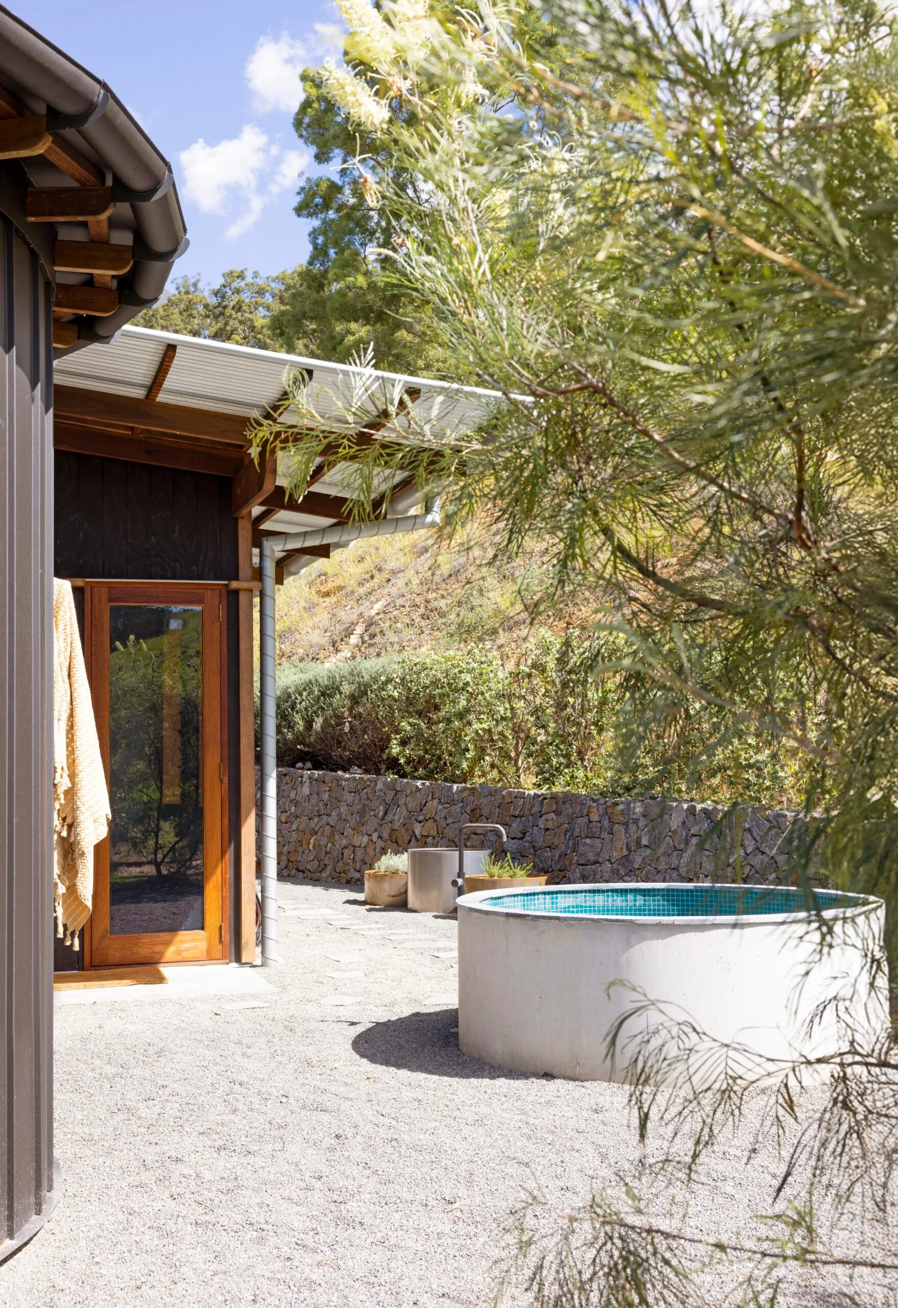 An alfresco bath made from an old cattle trough and pool tiles