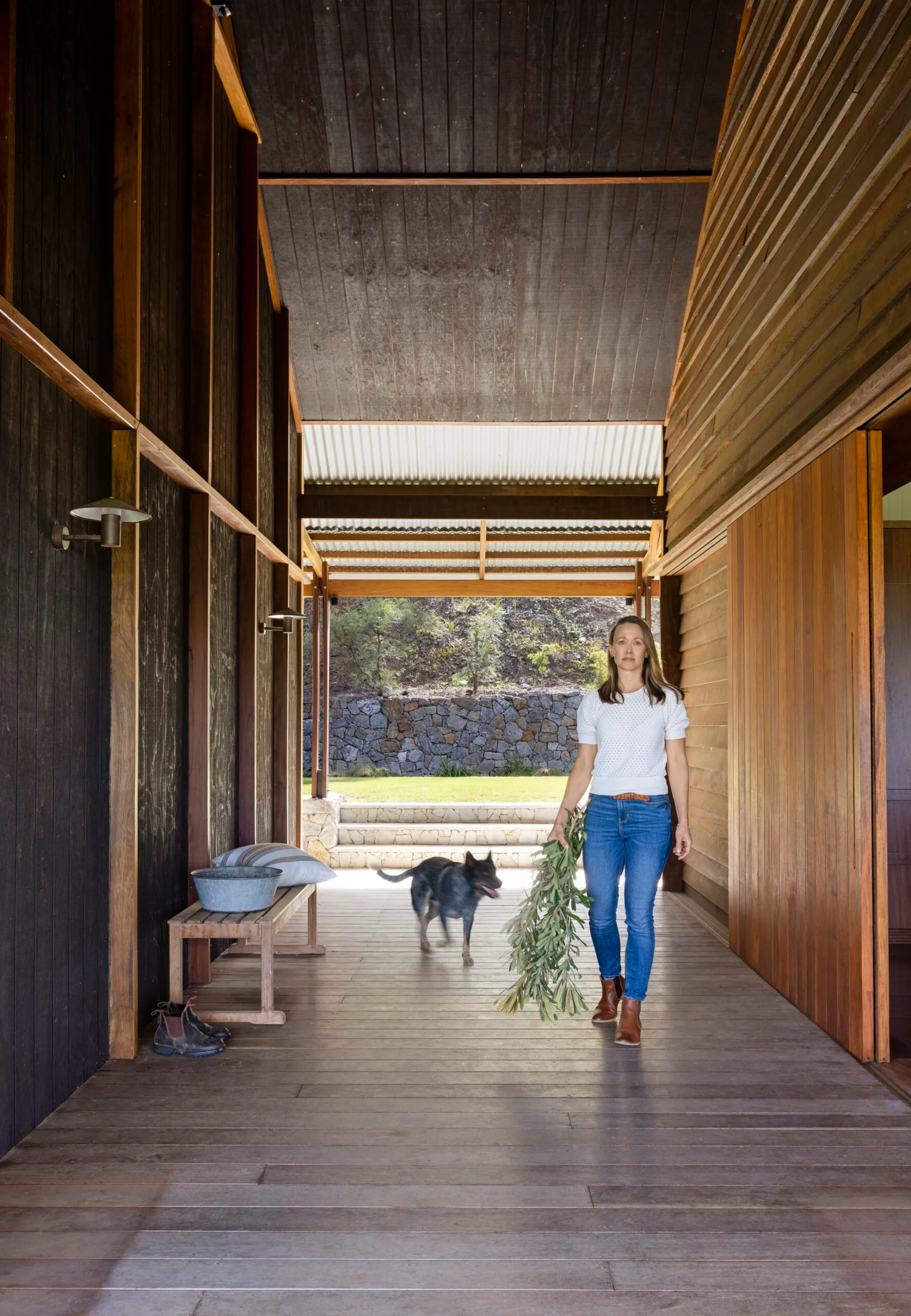 A women walks through an internal 'dogtrot' breezeway