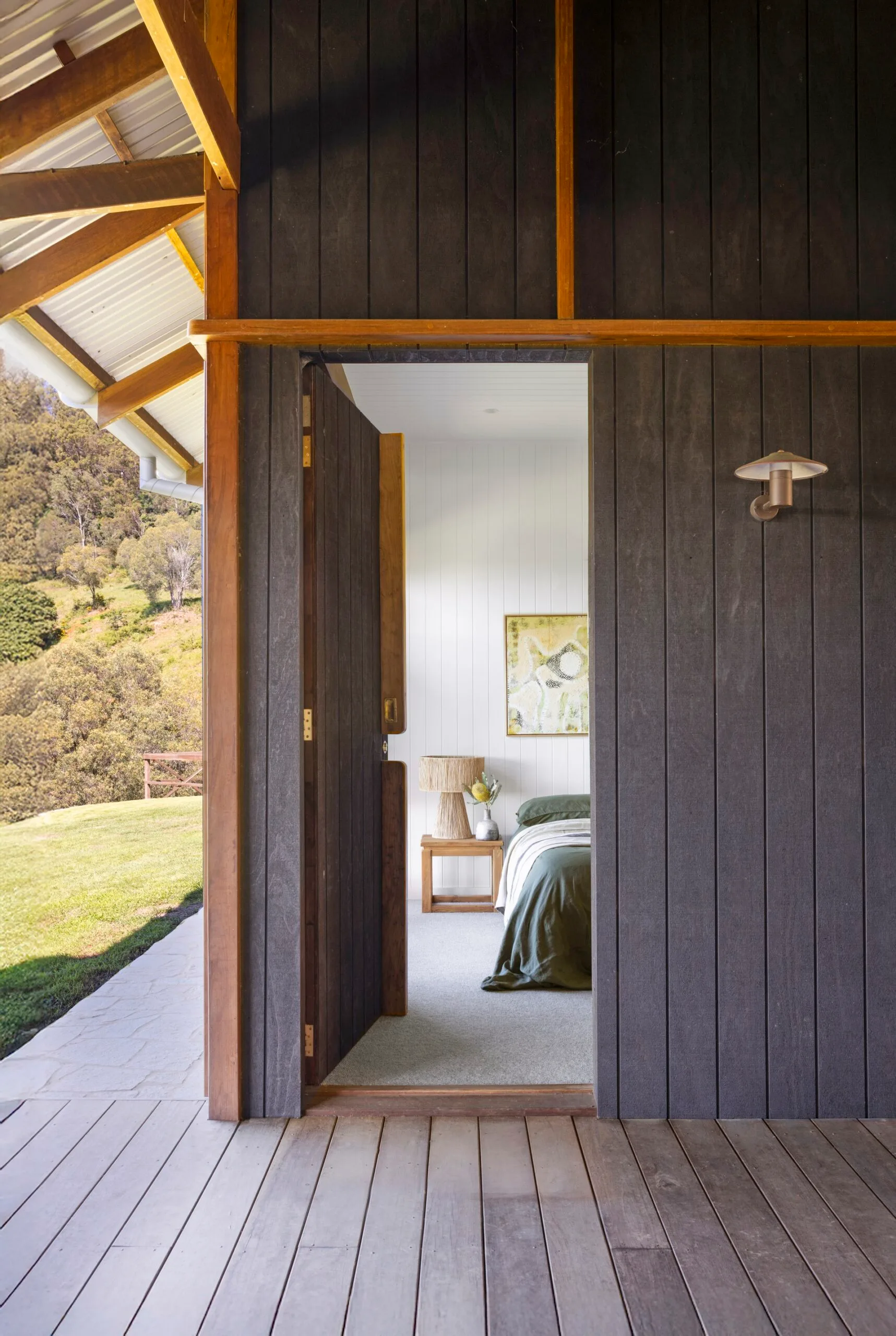 A bedroom with entryway onto a deck