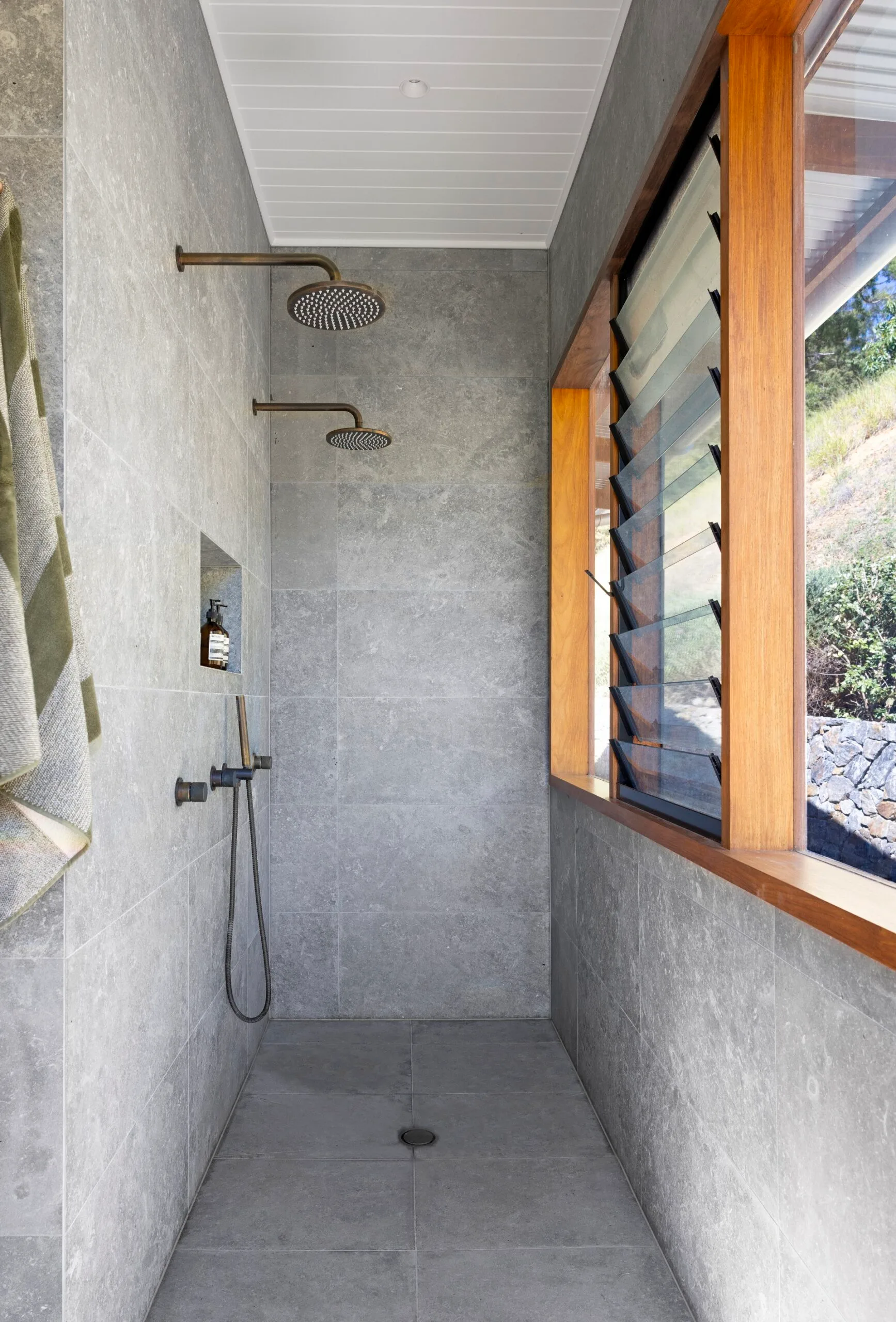 A double shower ensuite with grey limestone tiles.