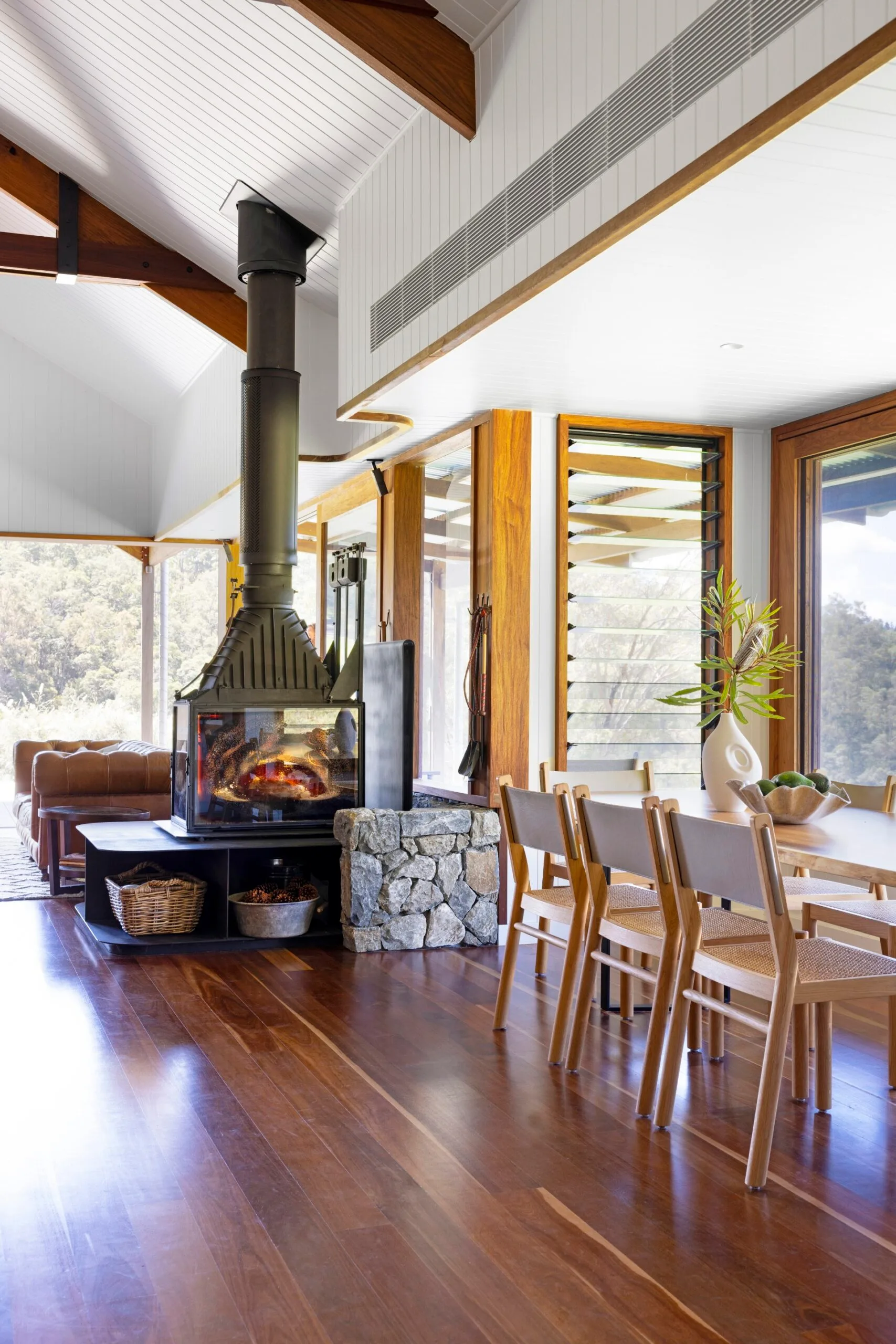 Open plan living and dining room with a log fireplace
