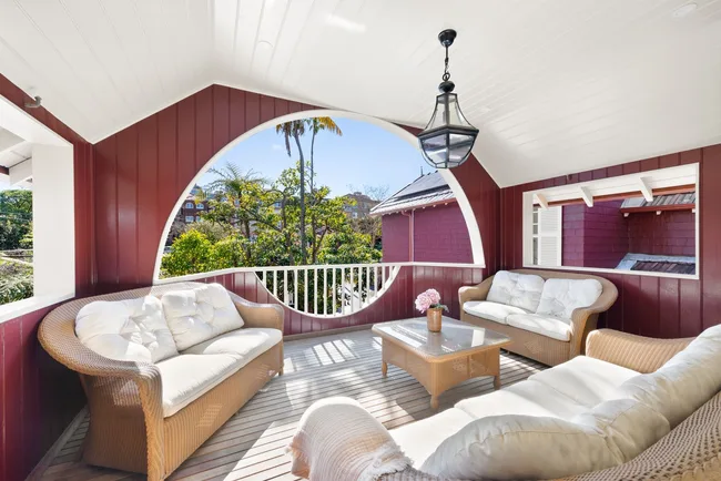 An enclosed balcony with lounges