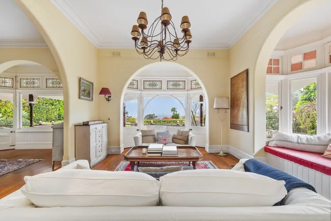 A living area with a chandelier and arched walls