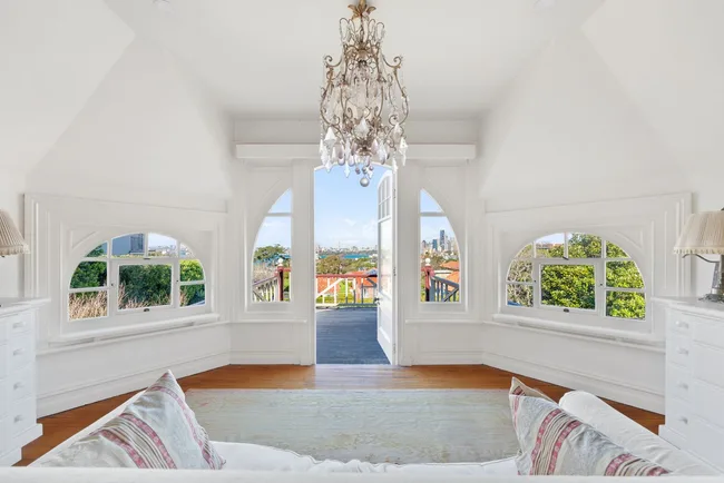 A white sun room with arched windows