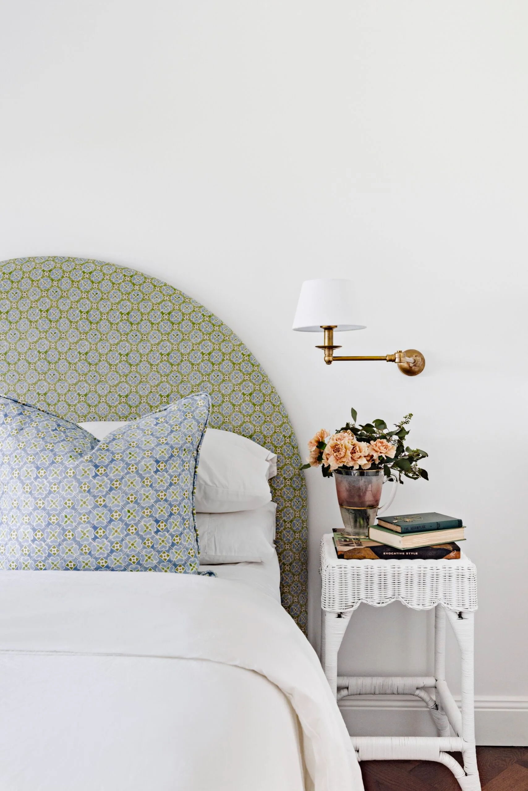 Pale blue and green upholstery in a white bedroom