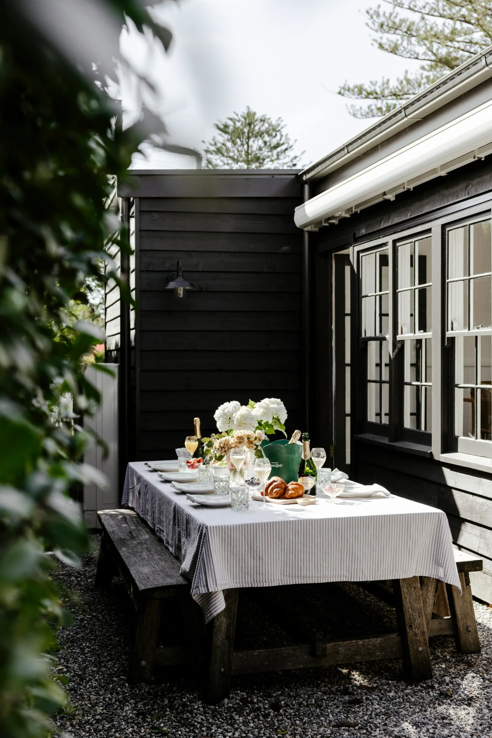 An outdoor dining scene with a full set table