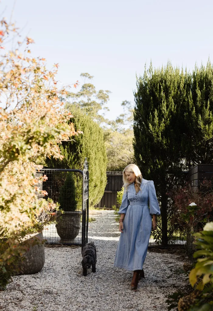 Natalie Hazel and her dog on her country property in berry surrounded by trees