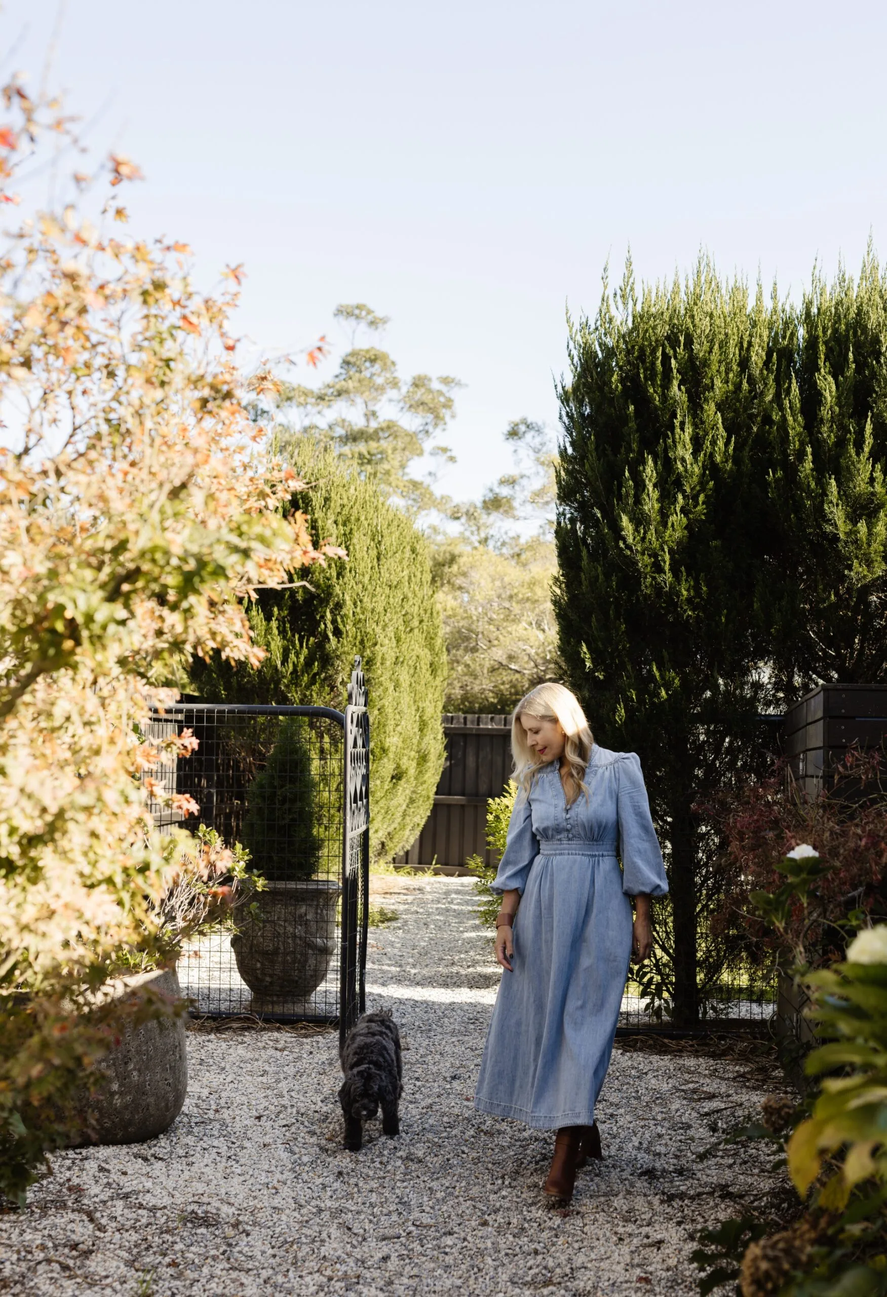 Natalie Hazel and her dog on her country property in berry surrounded by trees