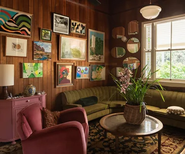 A vintage inspired country living room with eclectic gallery wall