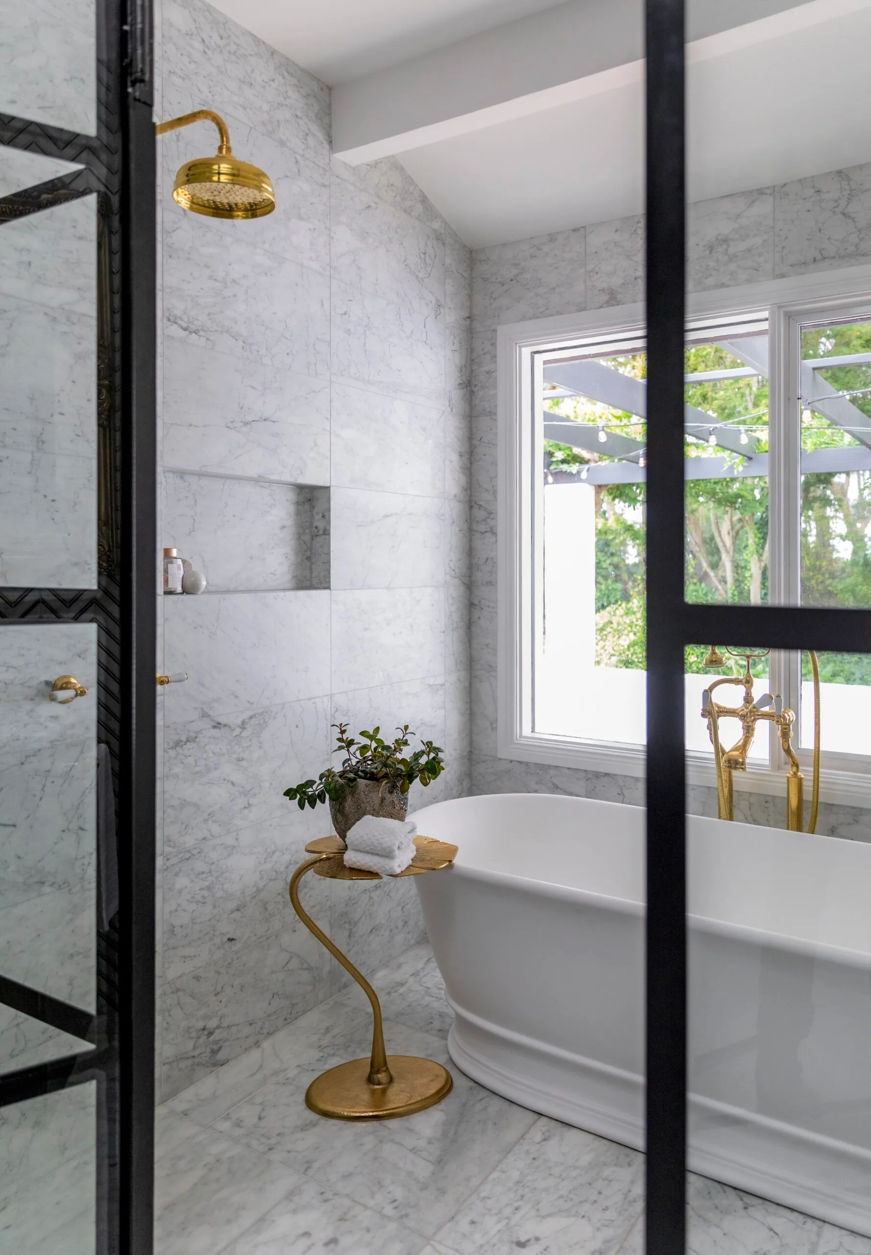 A marble bathroom with a freestanding bathtub