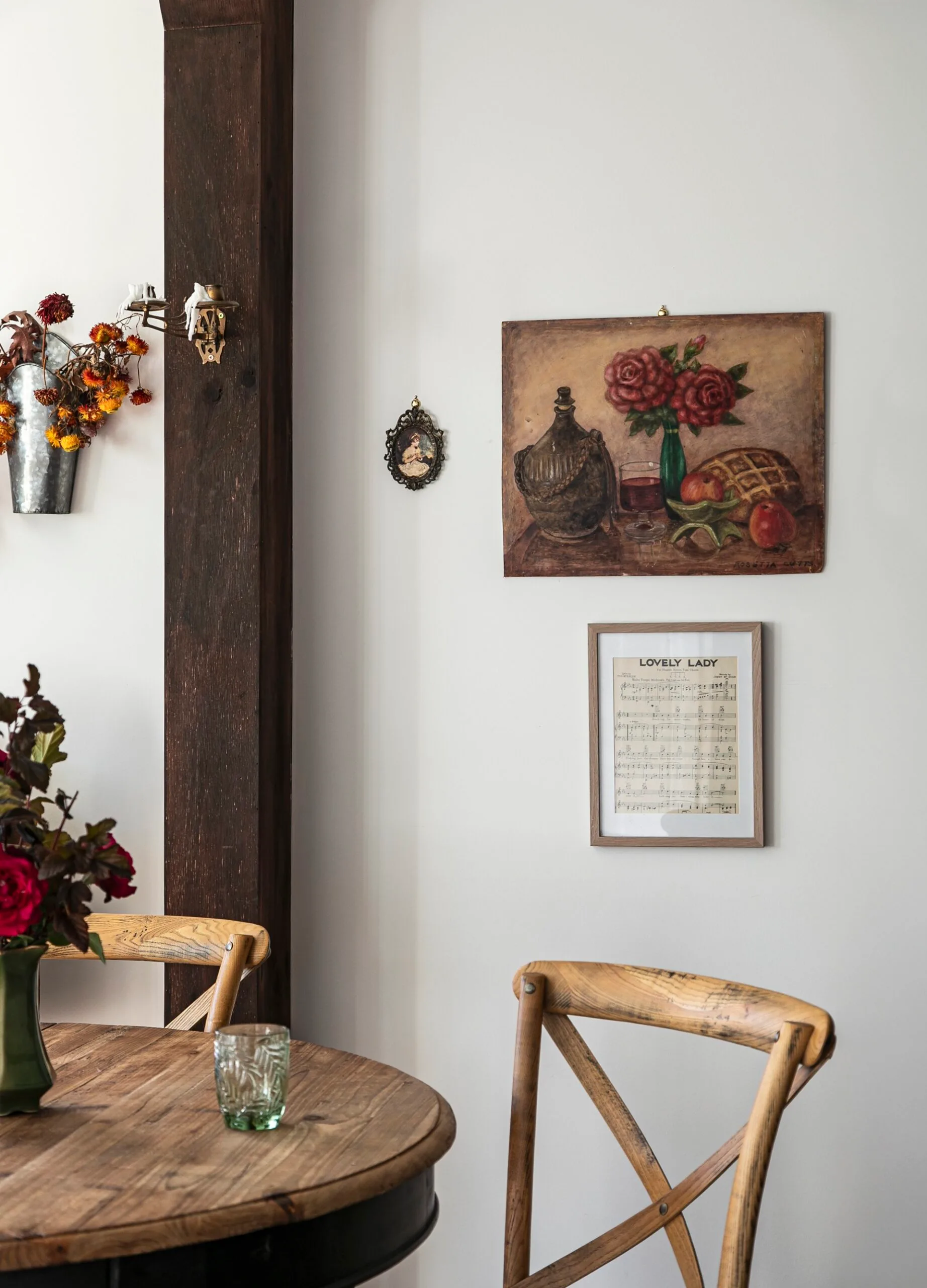 A country dining room featuring a vintage artwork and framed song lyrics.