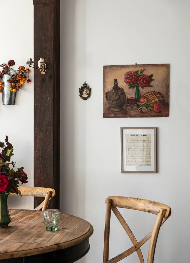 A country dining room featuring a vintage artwork and framed song lyrics.