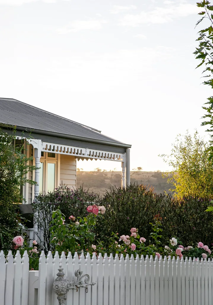 A country cottage surrounded by a rose garden.