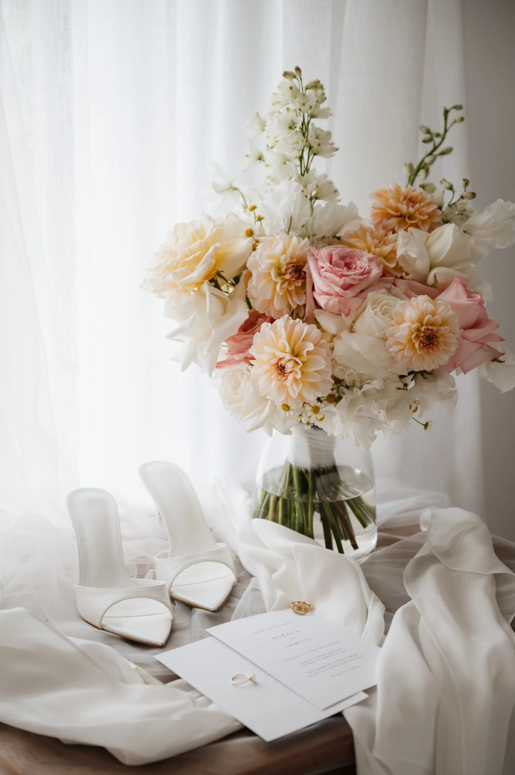 Bridal shoes, bouquet, invitations and wedding rings