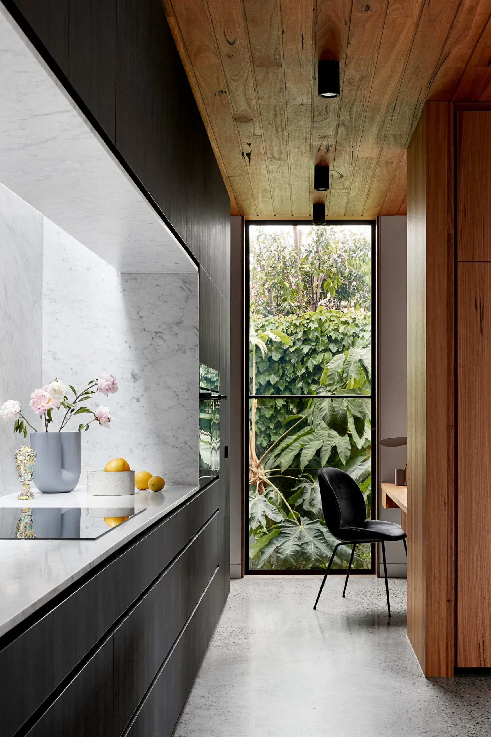 Modern kitchen looking out to lush greenery. Belle