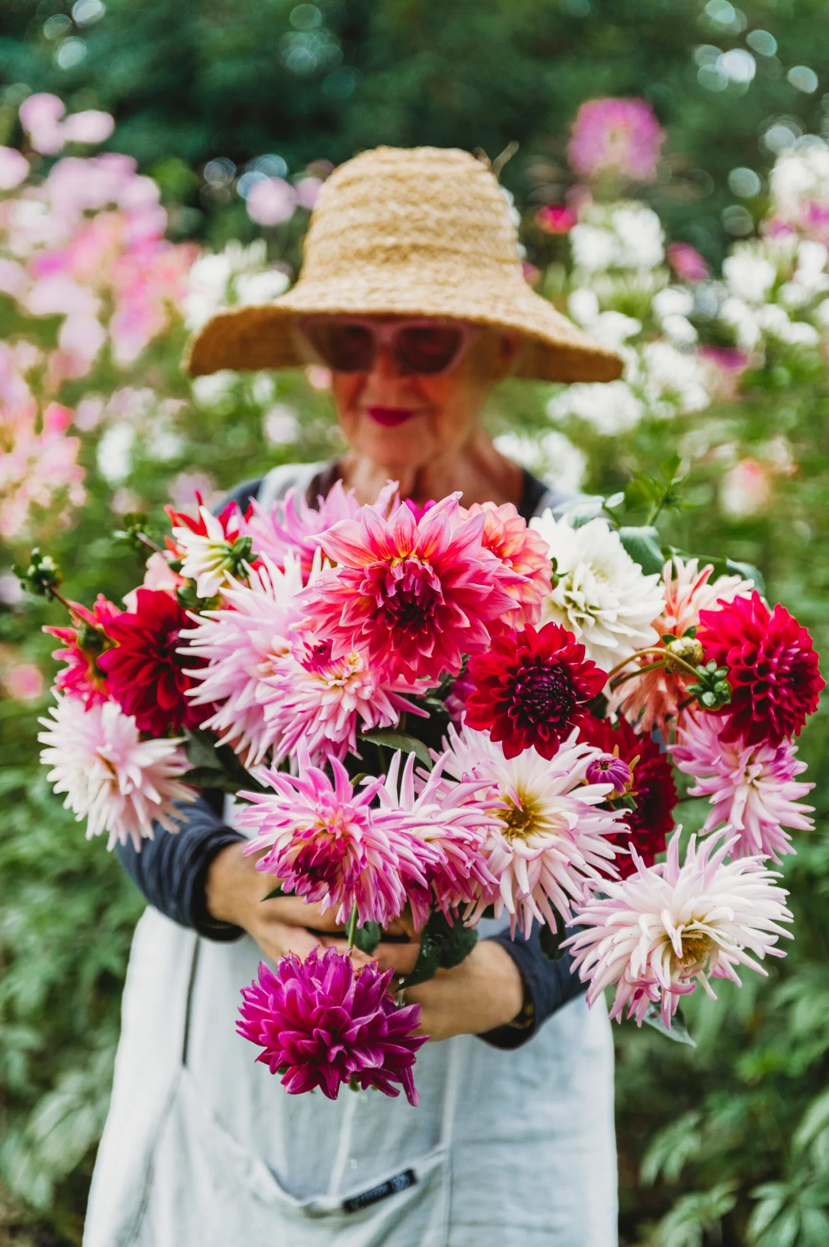 Suzy holding a bouquet of red and pink flowers