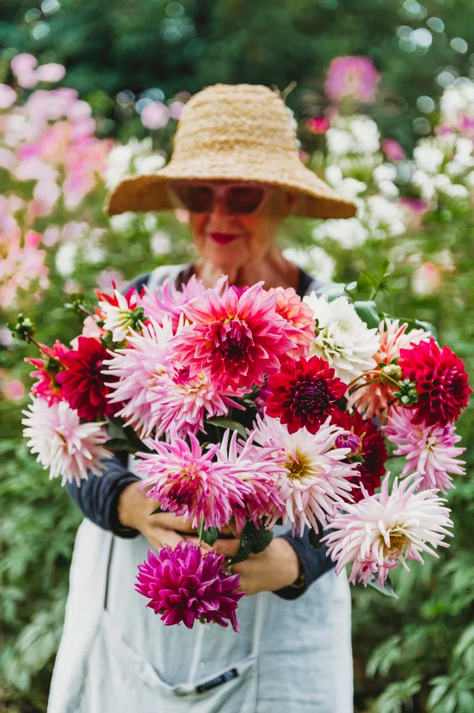 Suzy holding a bouquet of red and pink flowers