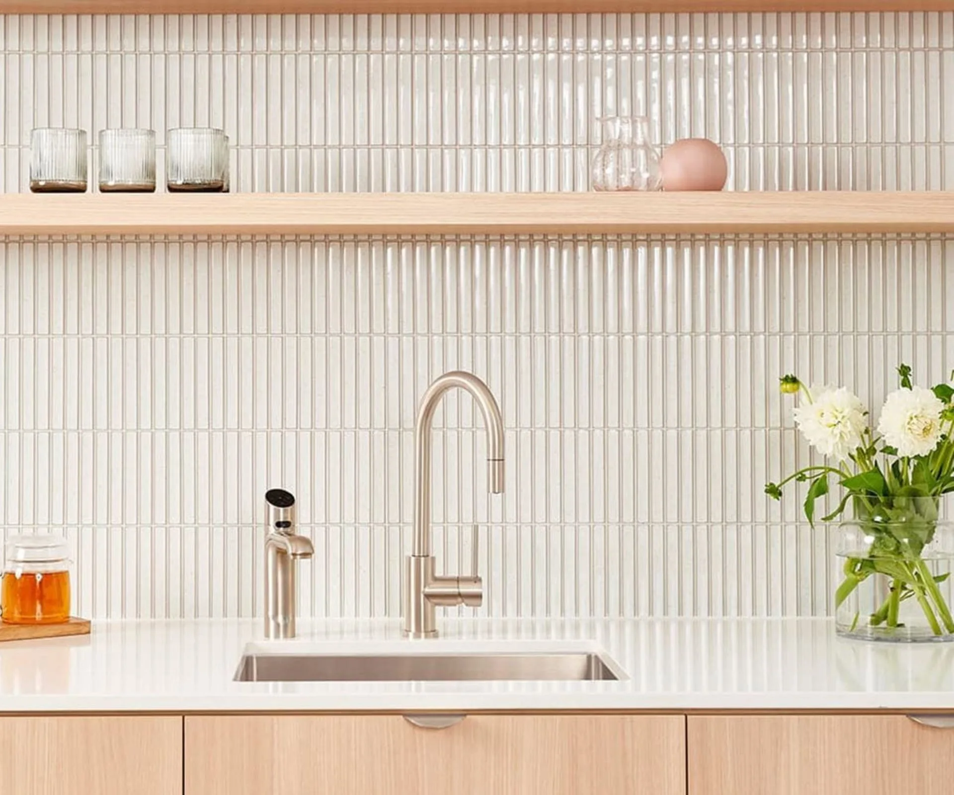Kitchen bench with sink and silver ZIP tap, white tiles