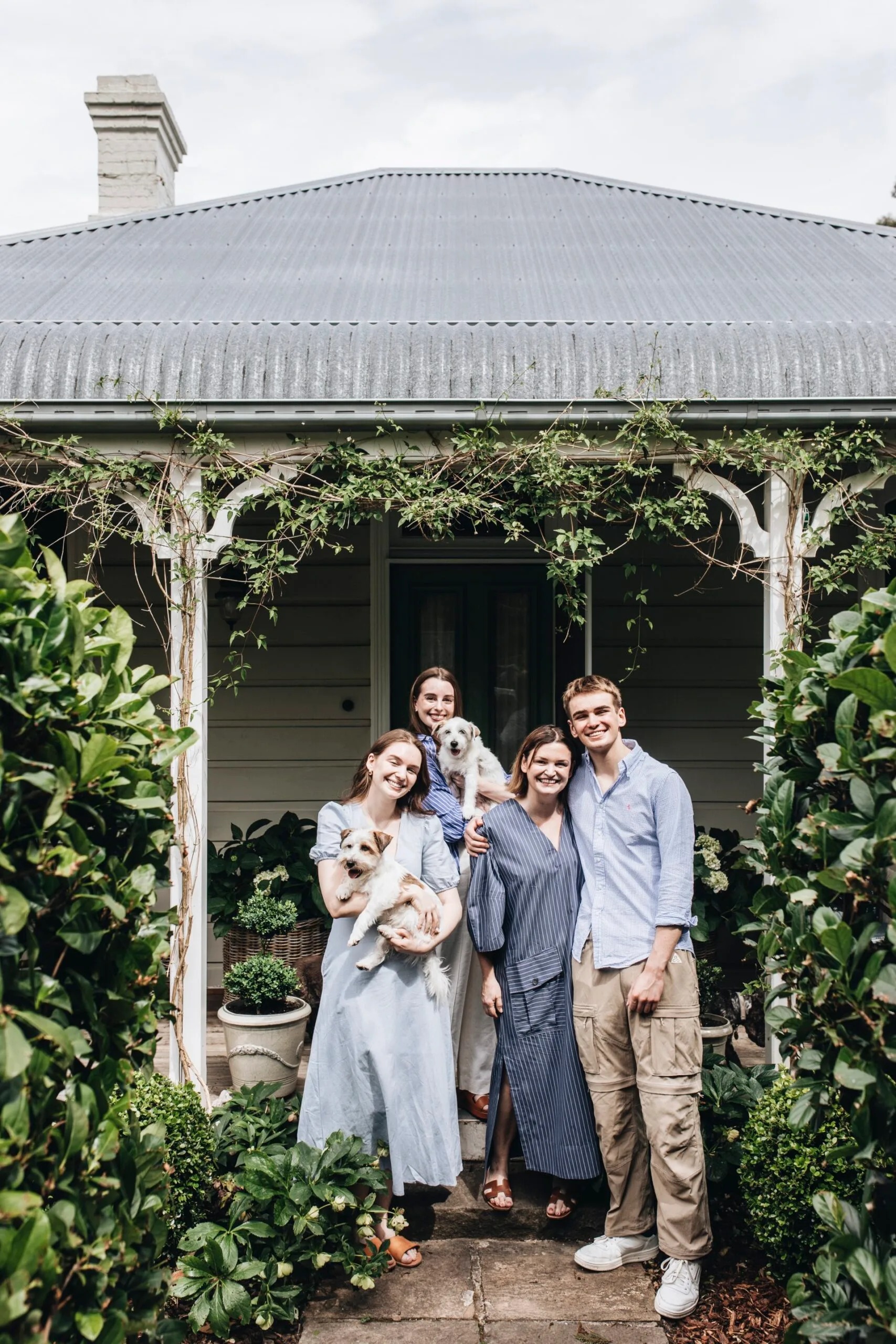 A family stand outside their renovated cottage in Bowral