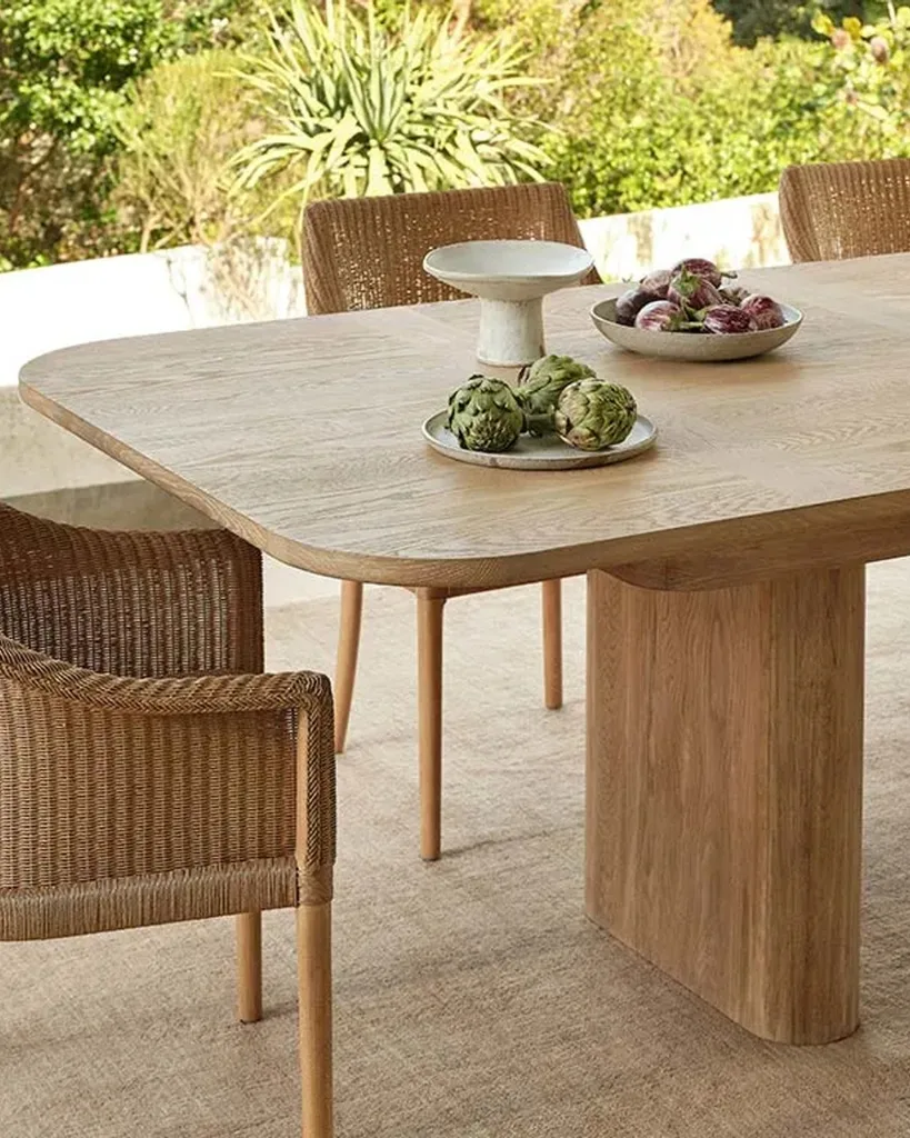 Natural oak dining table set shown outside from Coco Republic.